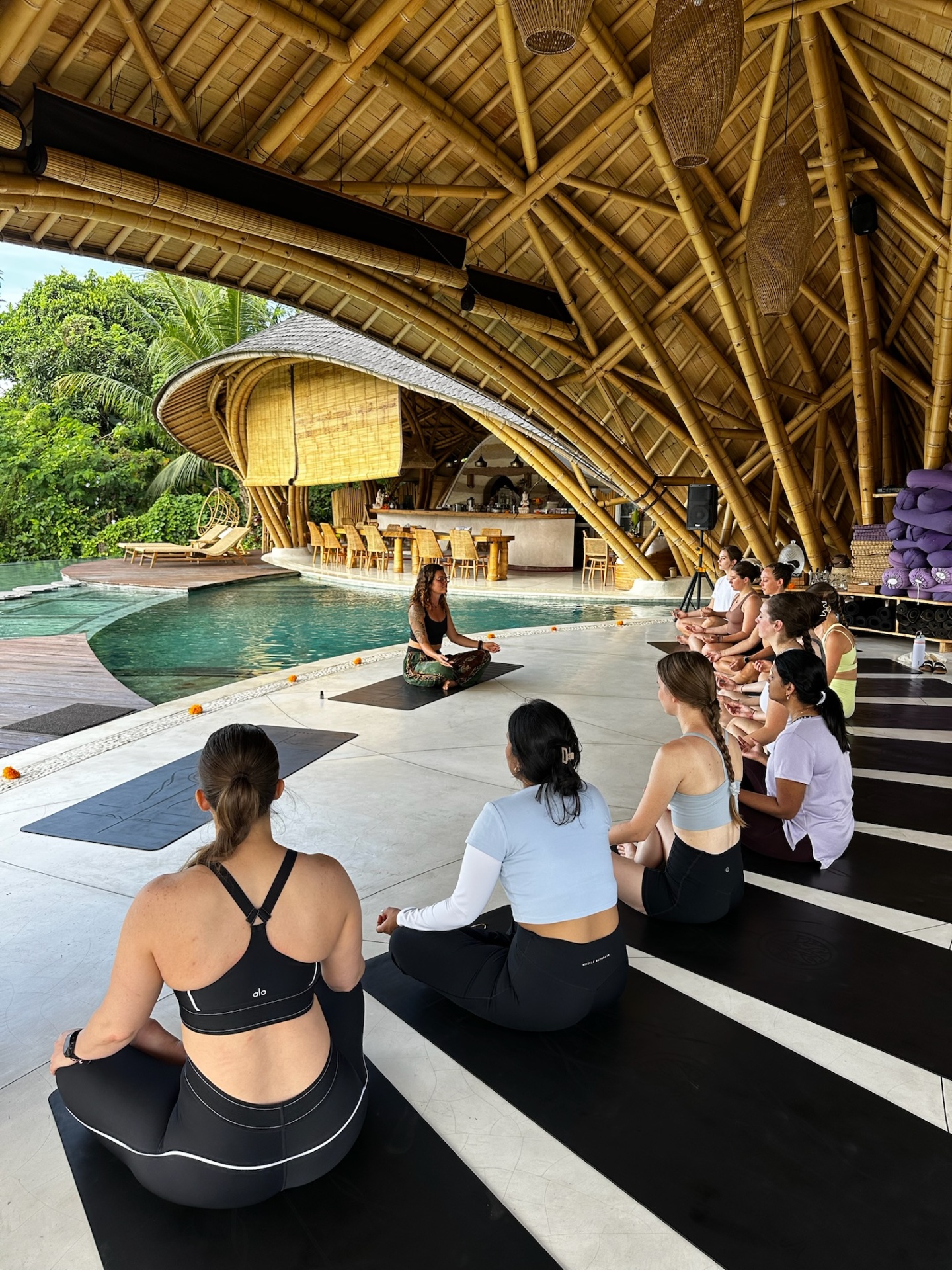 Group meditation by the pool in the jungle shala