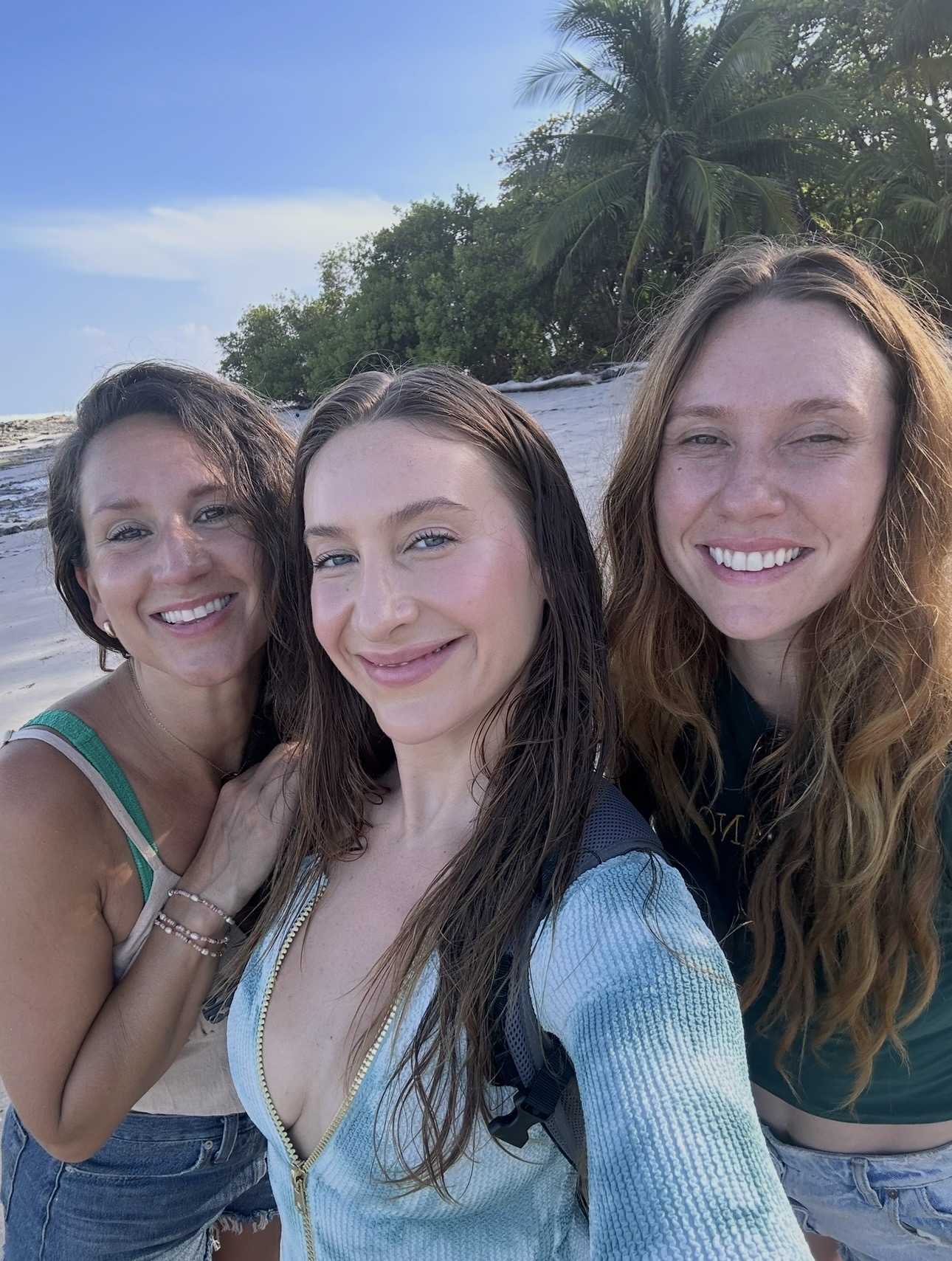 Three women smiling on the beach in Costa Rica